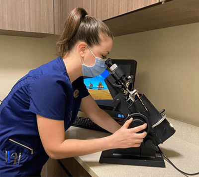 Woman Looking Into a Microscope
